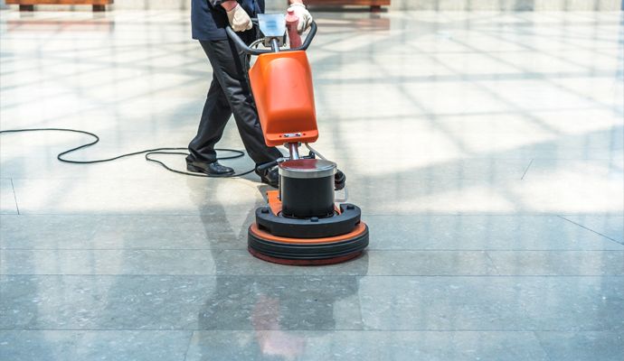 Person cleaning floor in a commercial space