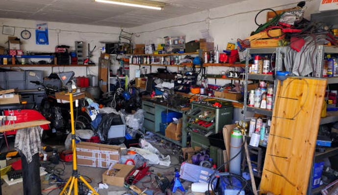 Messy space filled with tools boxes and equipment in need of organization