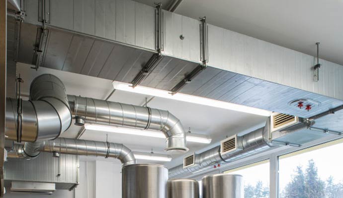 Commercial HVAC ductwork installed along an indoor ceiling