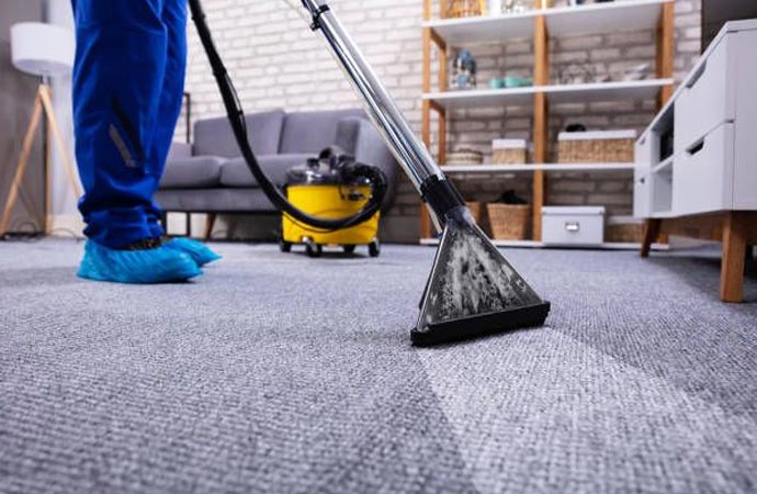 Professional cleaner using a machine to clean a carpet
