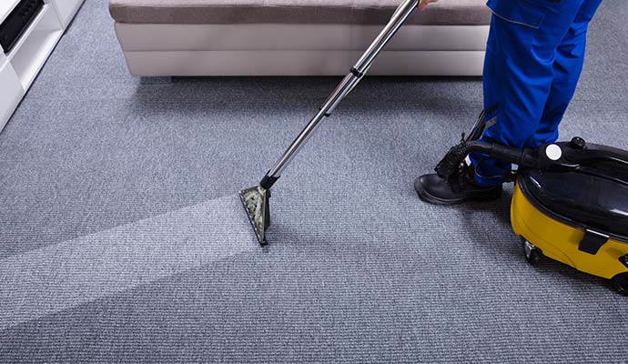 Hot water extraction carpet cleaning in a living room