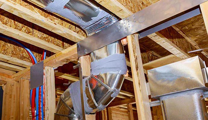 Metal air ductwork installed between wooden ceiling joists