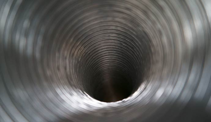 Close-up view inside a cylindrical metal duct or pipe