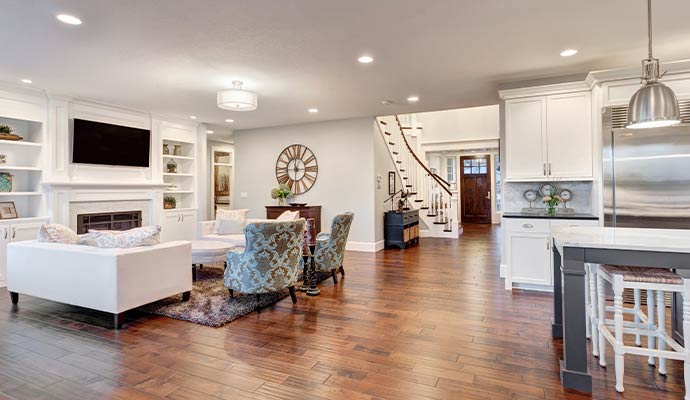 Clean living room with hardwood floors kitchen and seating area