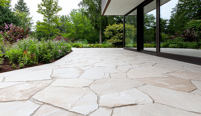 Modern flagstone patio with glass walls