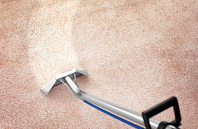 removing dirt from carpet with vaccum cleaner