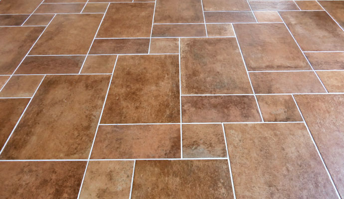 Terracotta tile floor with white grout lines