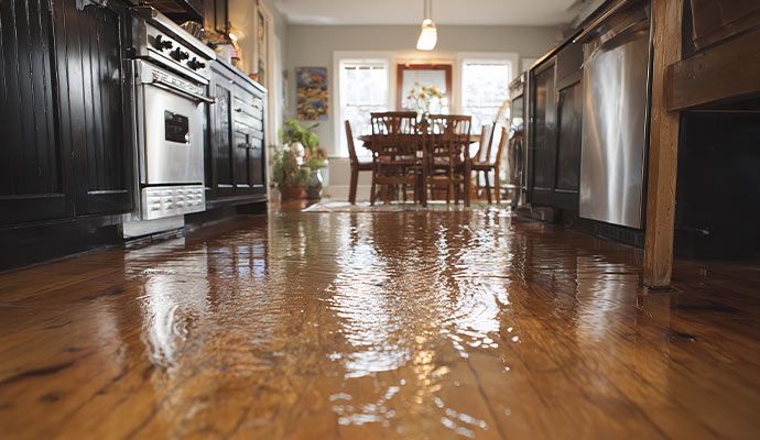 Water damaged wooden floor in kitchen