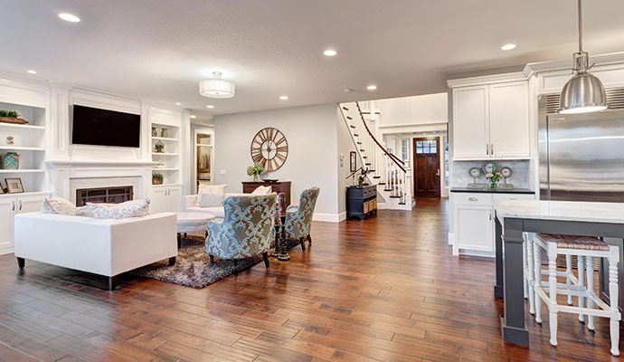 Modern open-concept living space with hardwood floors and cabinets