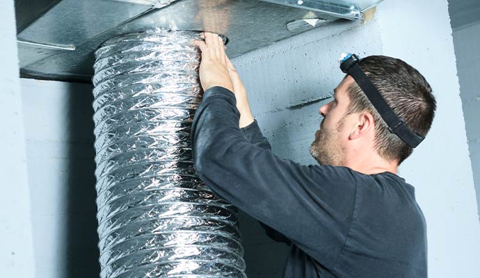 Technician installing flexible air duct