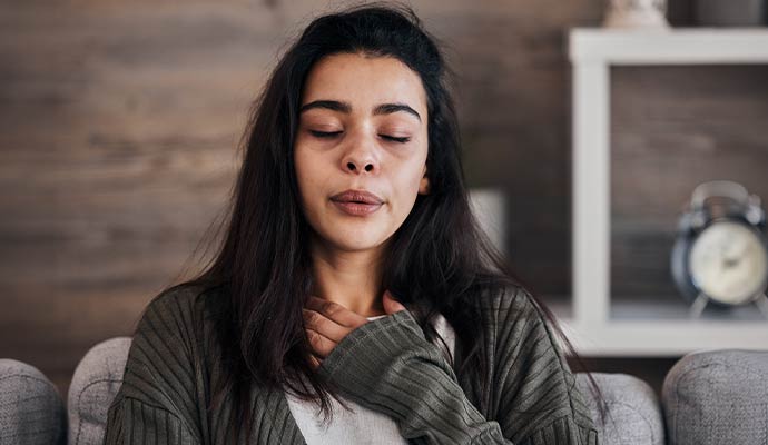 Woman struggling to breathe on couch